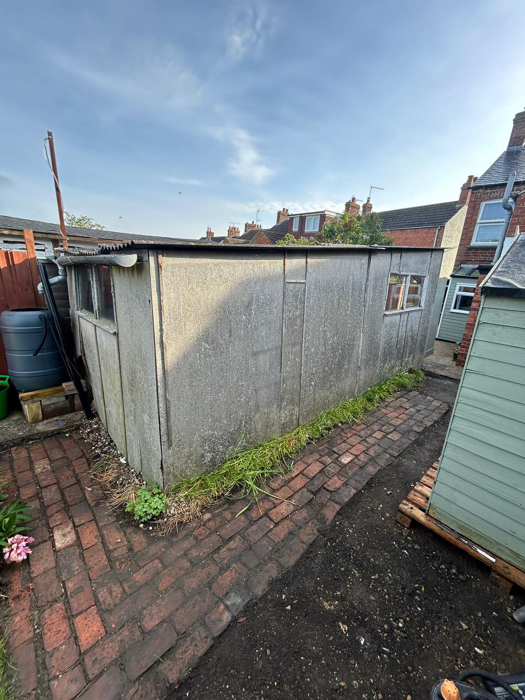 An old, unsafe garage with a suspected asbestos roof